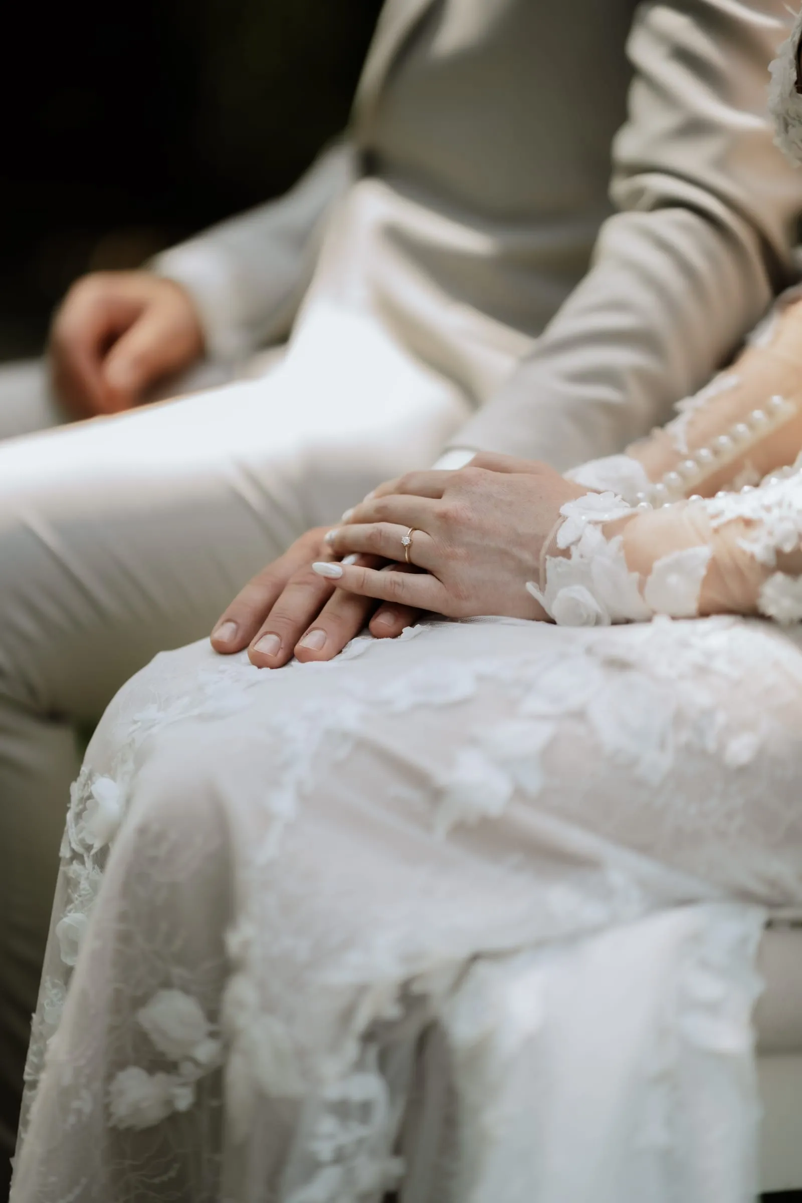 Seine Hand liegt auf ihrer, auf dem Spitzenkleid